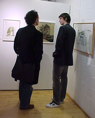 Two people studying the pictures